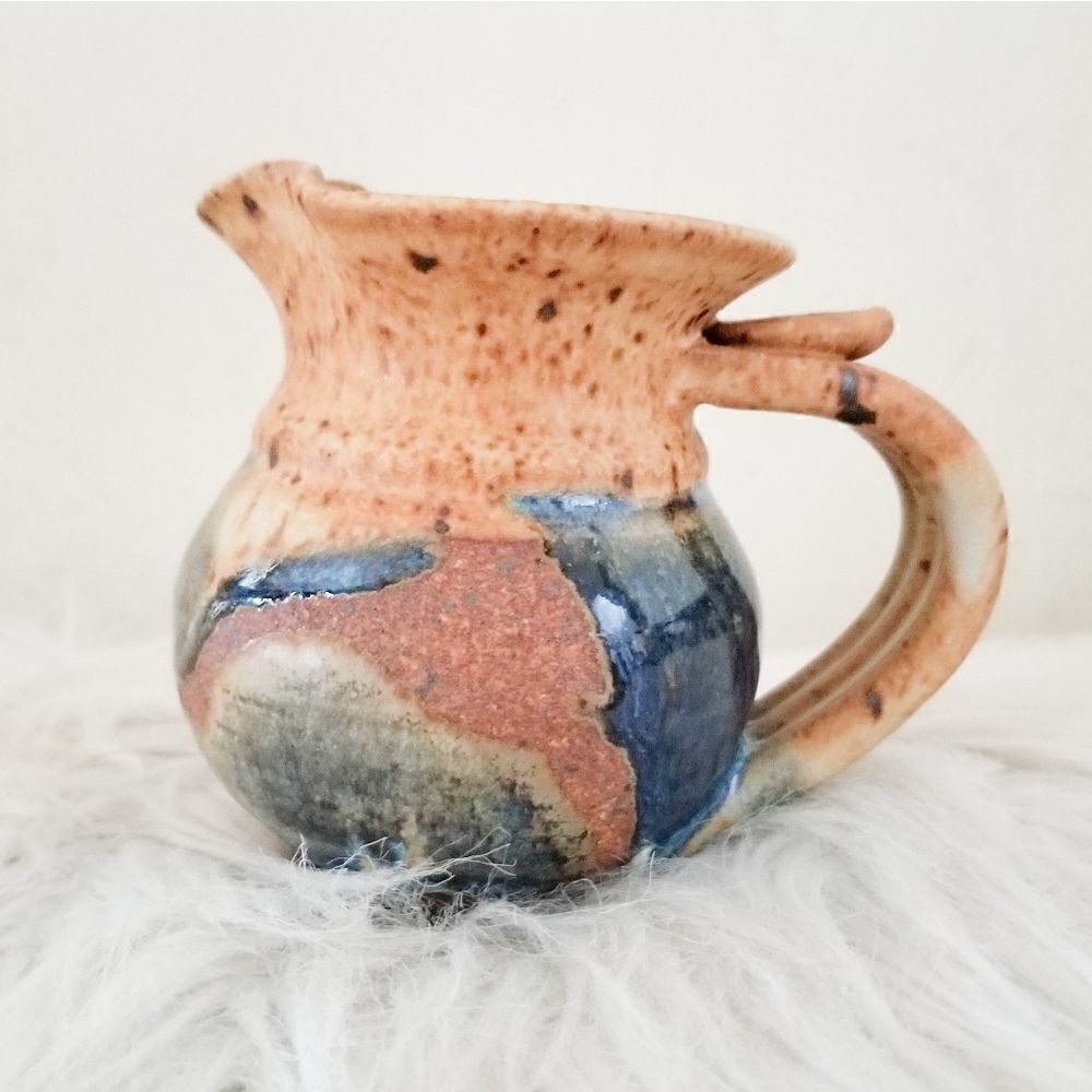 Pottery creamer signed by artist